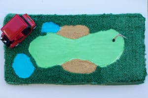 Golf course birthday cake with golf cart