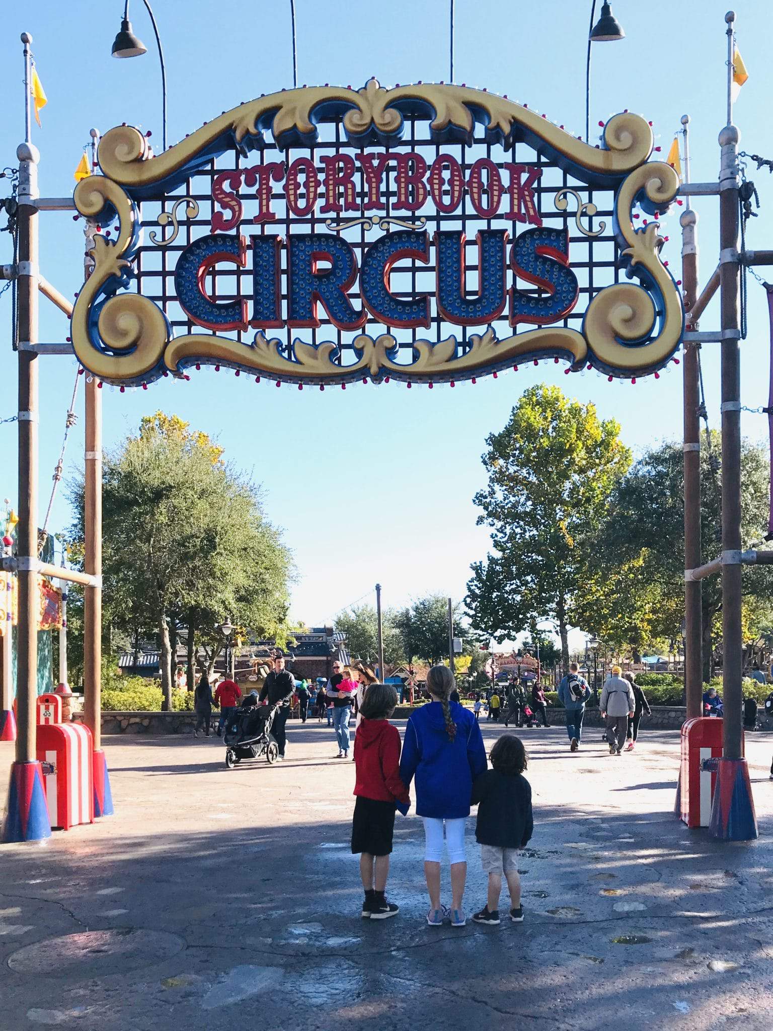 three kids entering storybook circus