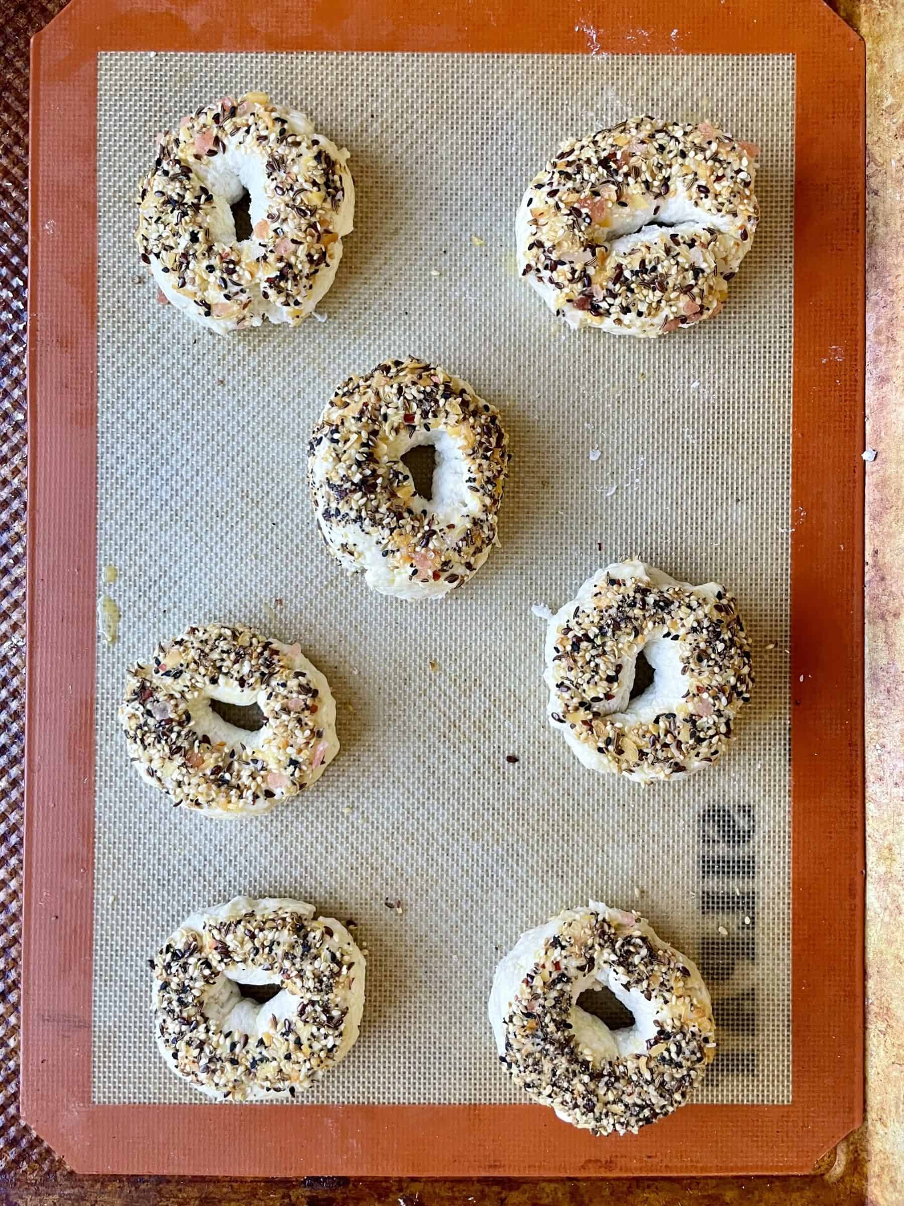 7 bagels on a silpat ready for the oven