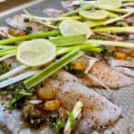 Solel and limes and scallions on a pan